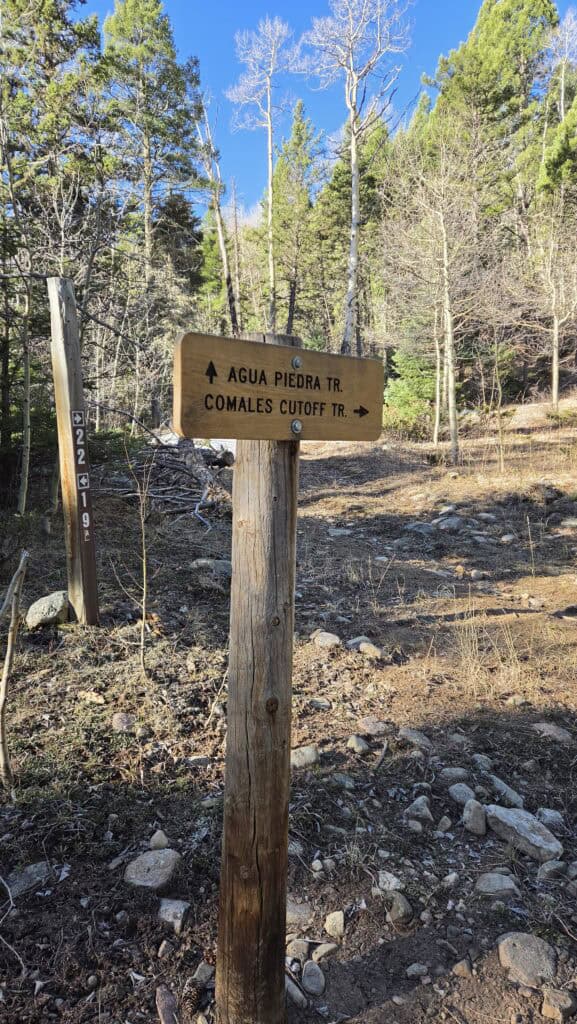 Hiking trail sign for Agua Piedra and Comales Cutoff in Santa Fe to Taos Thru-Hike, trail conditions.