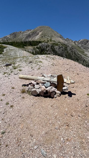 Scenic mountain landscape during the Santa Fe to Taos Thru-Hike with a makeshift trail marker.